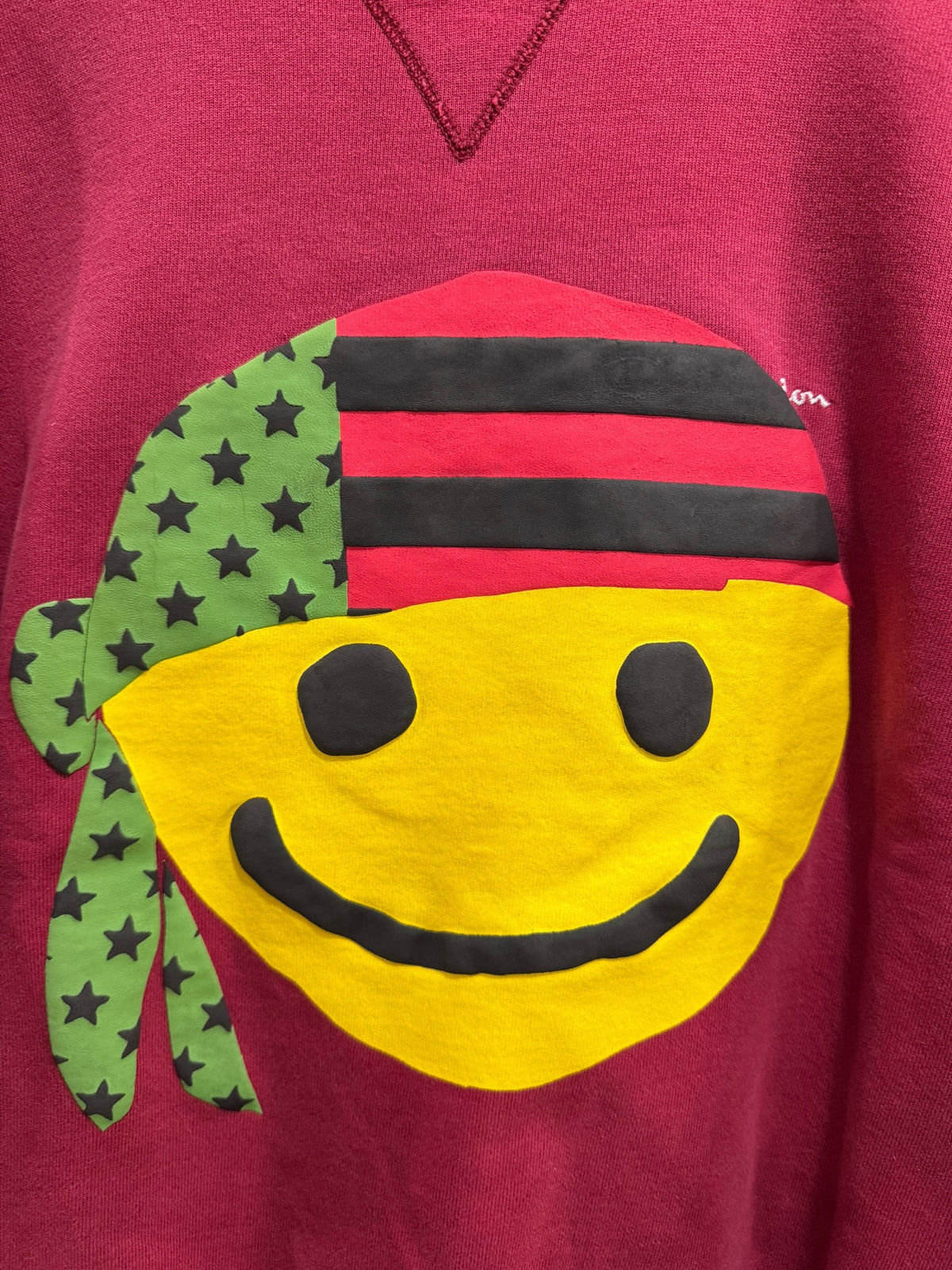 Denim Tears x Cactus Plant Flea Market Pan African Smiley Crewneck Dark Red