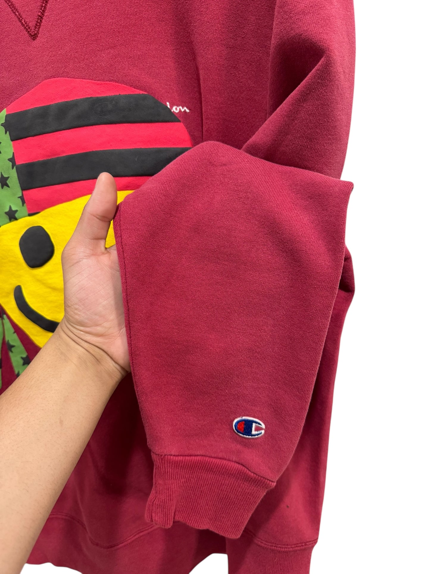 Denim Tears x Cactus Plant Flea Market Pan African Smiley Crewneck Dark Red